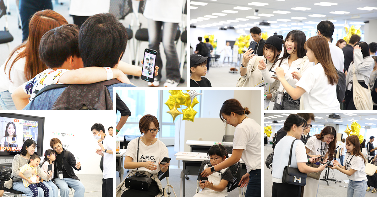 家族や友人がスマートフォンで写真を撮り合い、楽しそうに過ごしています。イベント会場は賑やかです。