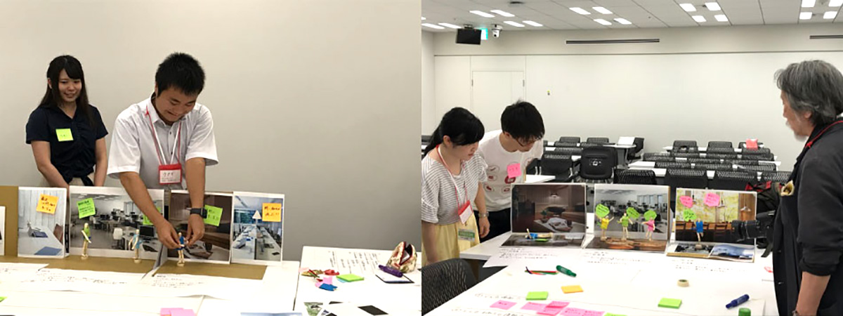 会議室でグループワークが行われています。参加者がテーブルを囲み、意見を交換しています。