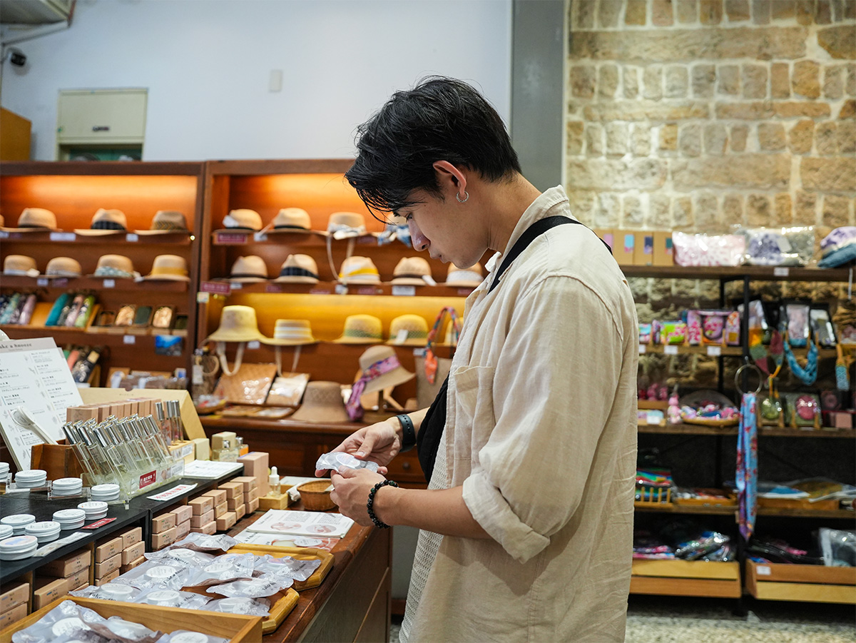男性が店内で商品を見ている写真です。棚には様々な商品が整然と並んでいます。