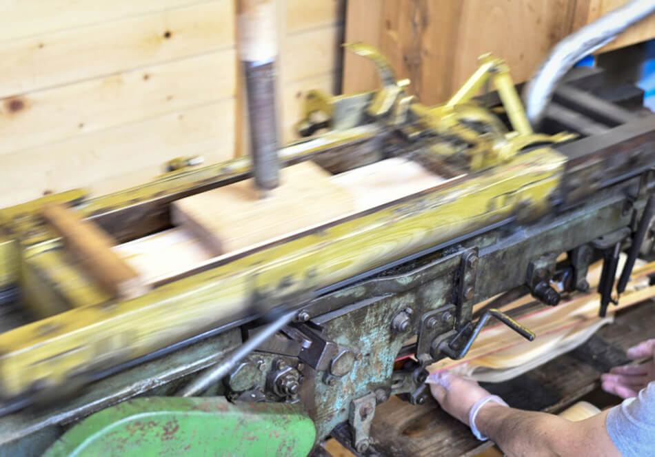 経木の製造機械は上から棒で押さえてスライドさせるシンプルなつくり